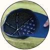 Close-up of a navy blue baseball cap with a hand holding the side, showing the interior lining printed with the brand name 'IRON GOAT' and small white logos, set against a blurred green grass background.